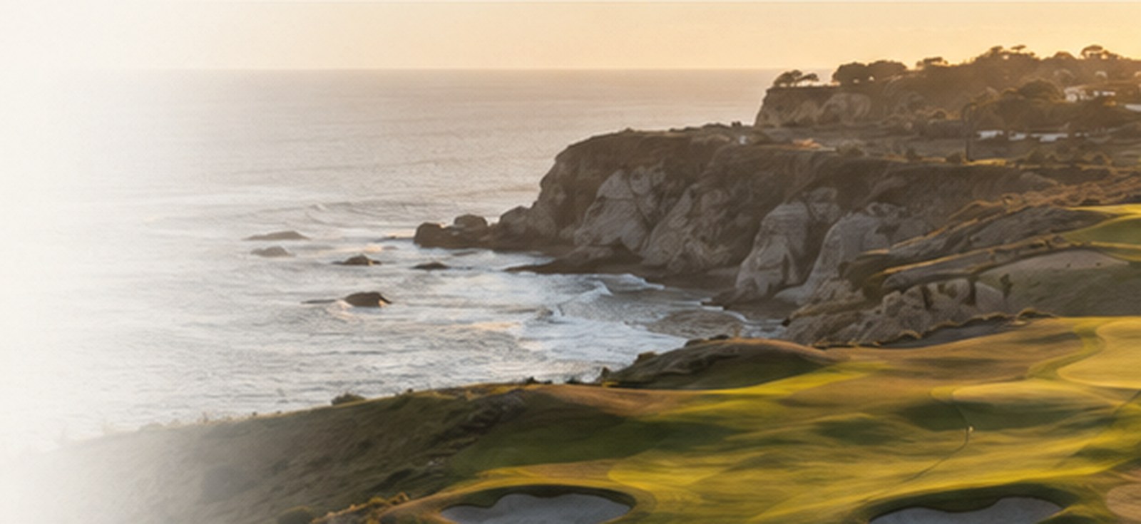 A coastal golf landscape in warm evening light